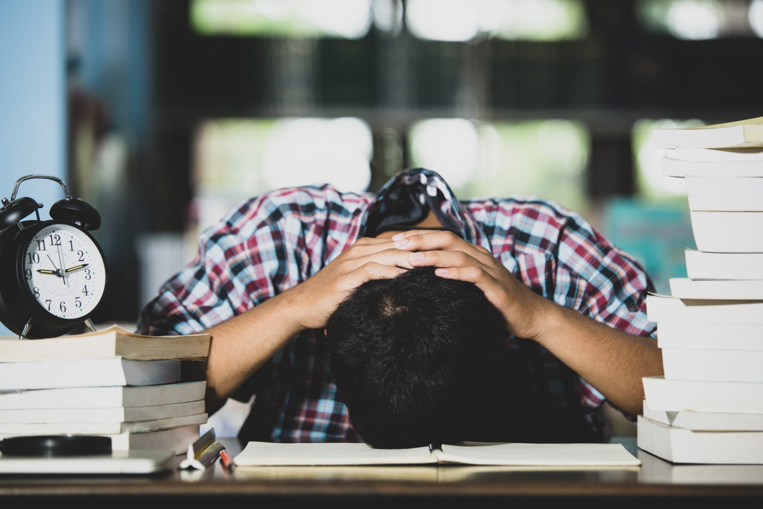 educational-conept-tired-student-library-scaled